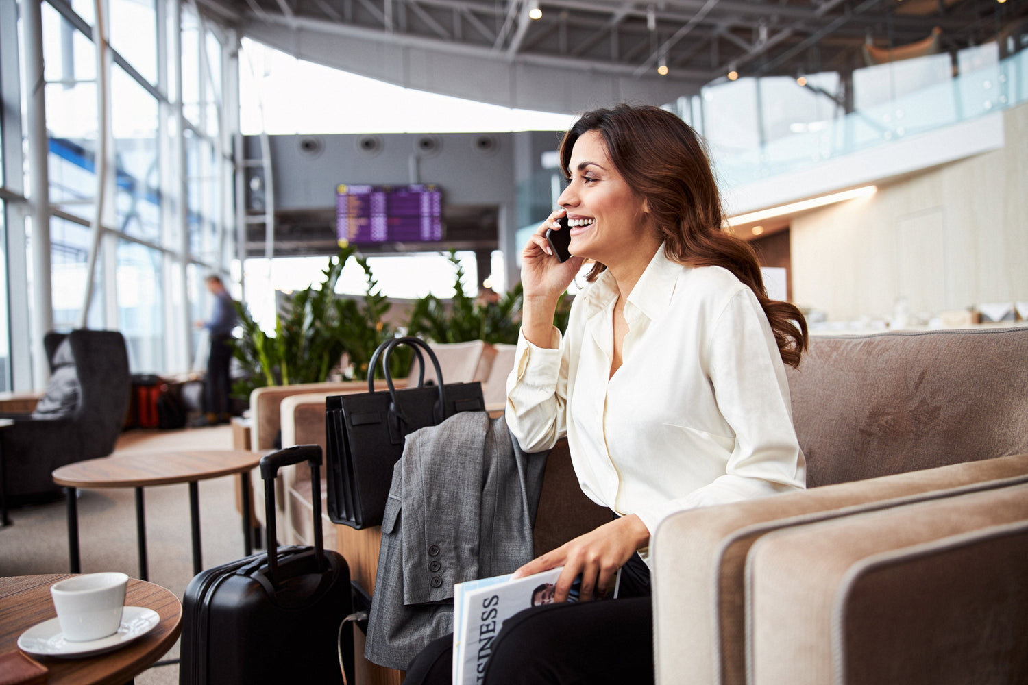 Woman sitting in an airport lounge talking on her phone